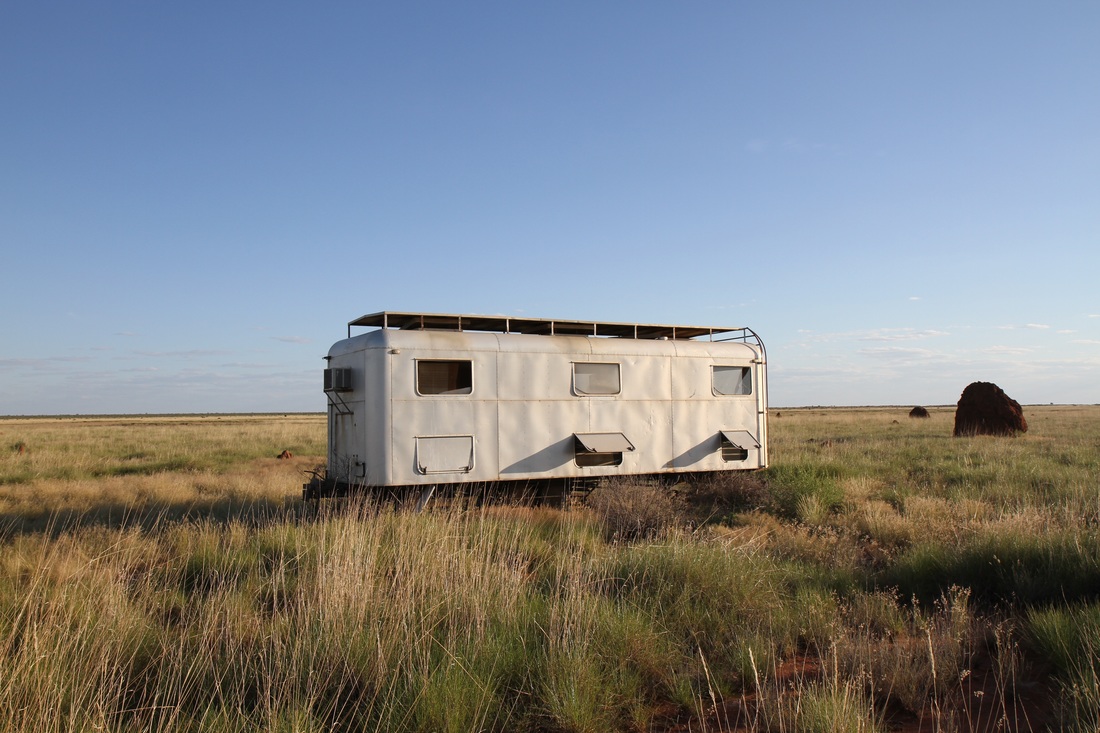 Trailer in Australian outback among small plants 